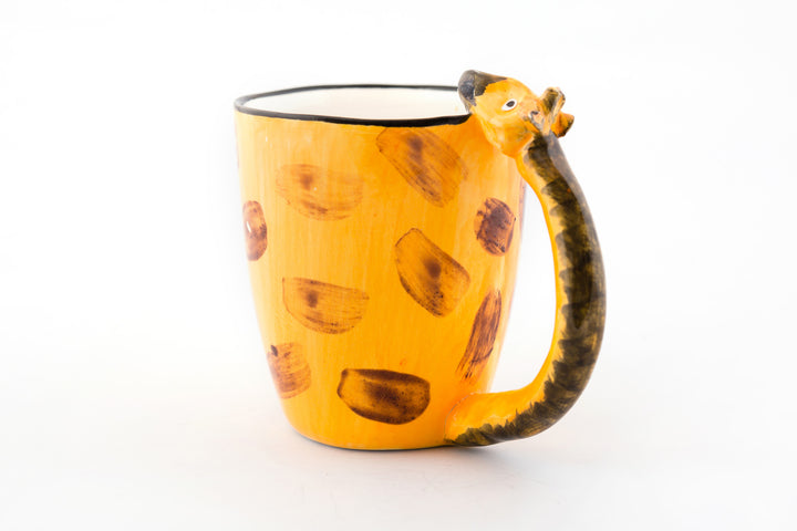 Ceramic coffee mug with a Giraffe neck for the handle and his head resting on the lip of the mug -darling! Painted in giraffe skin colors of yellow & brown.