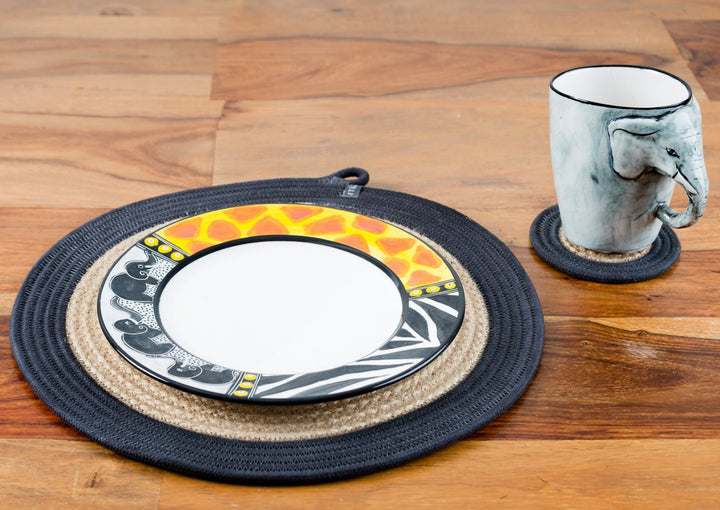 Whimsy Animal print side plate! White plate with the rim painted in zebra & giraffe print and three small elephants in a line on a woven place mat with the Elephant mug alongside. Great pair!