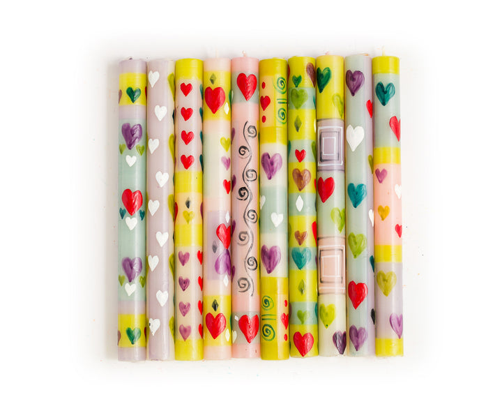 The photo shows the 10 designs included in the Pastel Hearts candle collection hand painted on 9" dinner tapers.