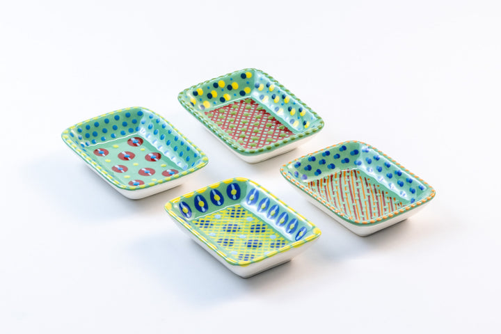 4 ceramic rectangle Tiny Bowls with Jasper green base color. Dots & Stripes painted on top in yellow, red, blue and orange.  