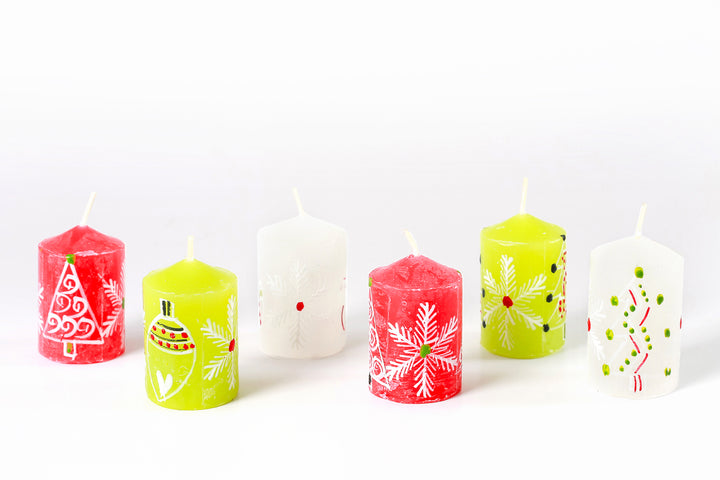 Whimsy Christmas votive candles!  These come in a 6-pack.  6 votives in the photo; 2 with red base color, 2 with green base color, and 2 with white base color.  All hand painted with trees, snow flakes and Christmas ornaments in white with red, green highlights.