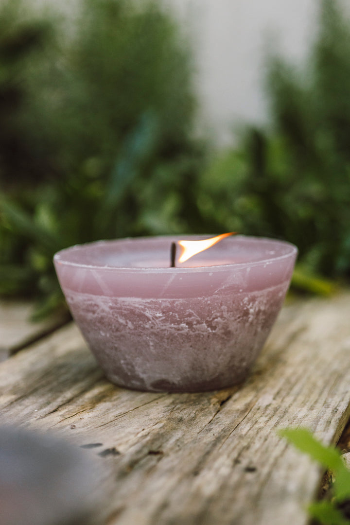Outdoor bowl candle in dusty pink burning in the garden. Thick wick - looks beautiful!