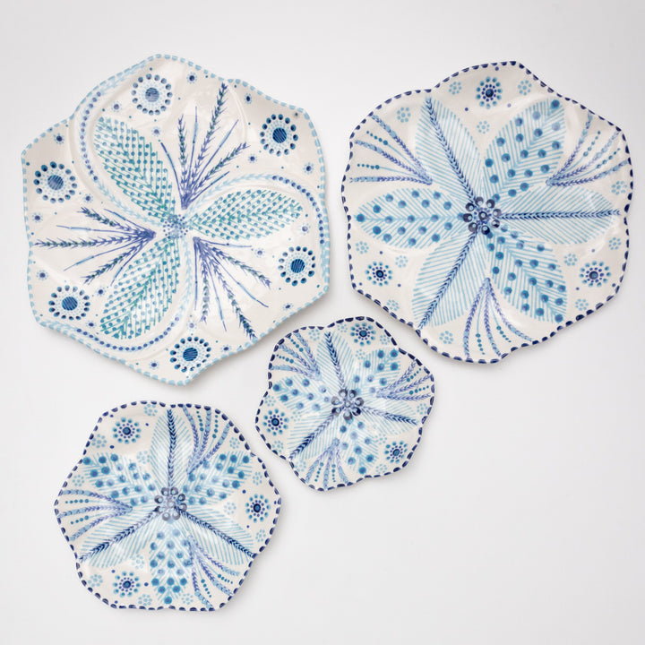 Ceramic large dinner plate, dinner place, side plate and cocktail plate. White background with indigo blue floral design.