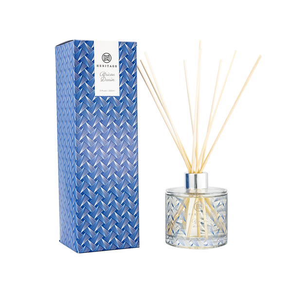 African Denim 200ml diffuser. The blue pattern on the gift box and glass diffuser is the pattern of denim worn by the Zulu women.  The diffuser has natural color reeds.