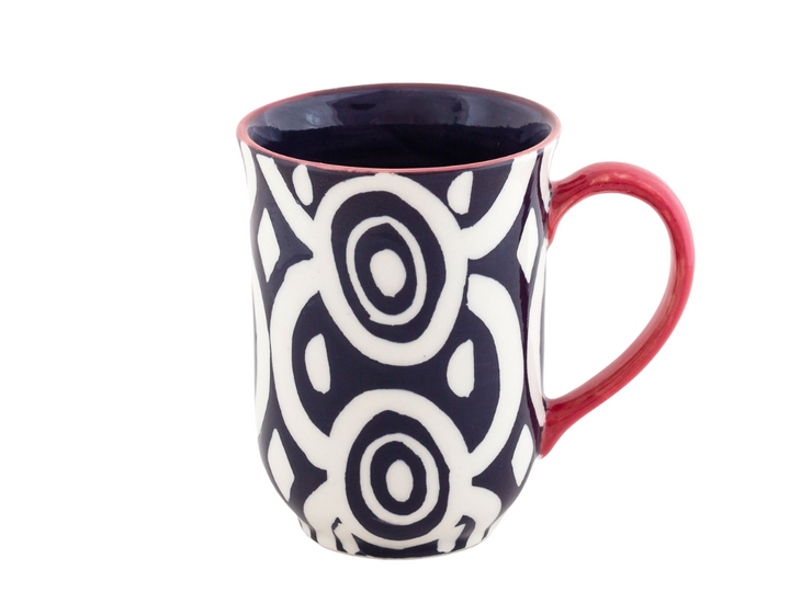 Batik hand poured and hand painted mug.  Indigo blue and white geometric designs on classic shape mug, with red handle and trim. Dark blue inside.  Microwave and dishwasher safe.