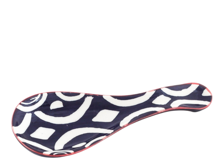 Batik design ceramic spoon holder.  Dark blue and white geometric design with red  trim.  Dark blue on back.  Fair Trade.
