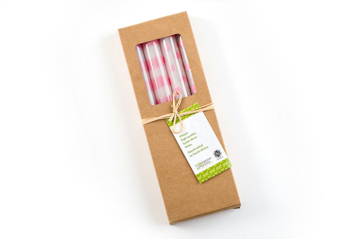 Gift box of 4 taper candles; 2 are white taper candles with pink dots and two are white taper candles with pink stripes. 