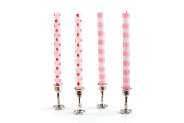 4 taper candles in pewter taper candle holders.  Two white taper candles with pink dots, and two white taper candles with pink stripes.