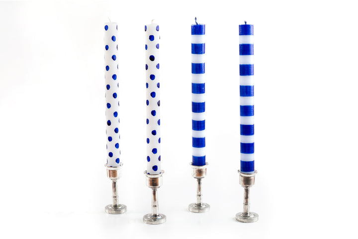 4 taper candles in pewter candle holders.  Two are white with blue dots and two are white with blue stripes.  Fair Trade.