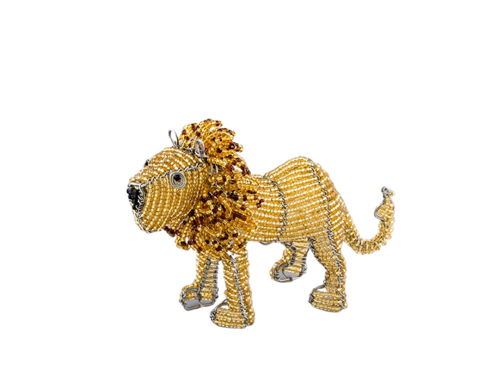 Beaded lion figurine. Made from recycled wire outline and beads strung throughout, of golden yellow and brown with a large whimsical mane. Fair Trade Decor. Fair Trade Gifts. Handmade Gifts. Handmade Decor. Handbeaded.