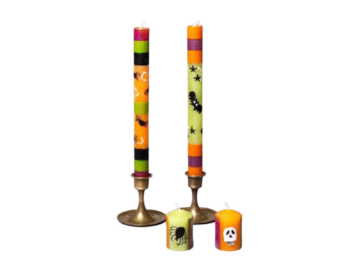 Halloween hand made and hand painted 9" dinner tapers. and 2" votives.  Painted in traditional Halloween designs; skulls, spiders, bats, and halloween colors. Taper candles are shipped in a match pair. Fair Trade.