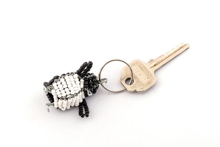 Beaded penguin key chain. Hand made with a black back and a white tummy, just like the tuxedo that a penguin wears!  Fair Trade products.