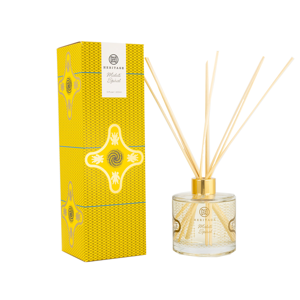 The Maluti Spiral 200ml room diffuser and gift box. The yellow & black pattern on the box and glass of the diffuser is the spiral aloe found in Lesotho. The diffuser comes with natural reeds as shown.