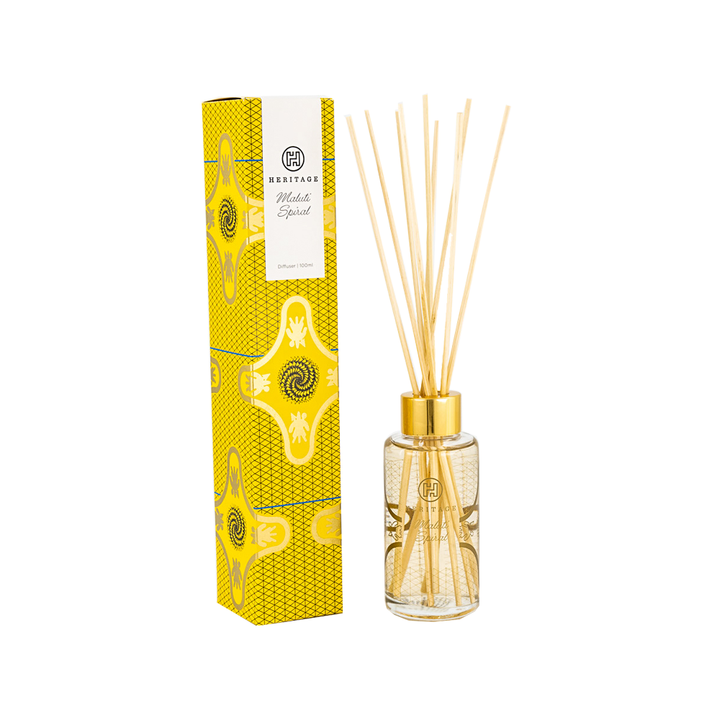 Maluti Spiral room diffuser and gift box.  The yellow & black pattern on the box and glass diffuser  is the spiral aloe found in Lesotho. The diffuser comes with natural reeds. 
