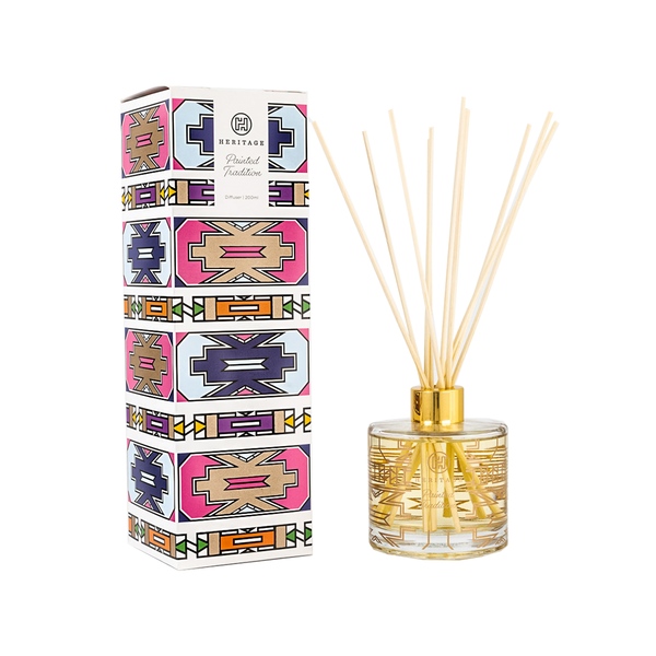 The Painted Tradition 200ml room diffuser and gift box. The gift box  has the colorful designs that the Ndebele women paint on their houses.  The glass of the diffuser has the same graphics and comes with natural reeds.