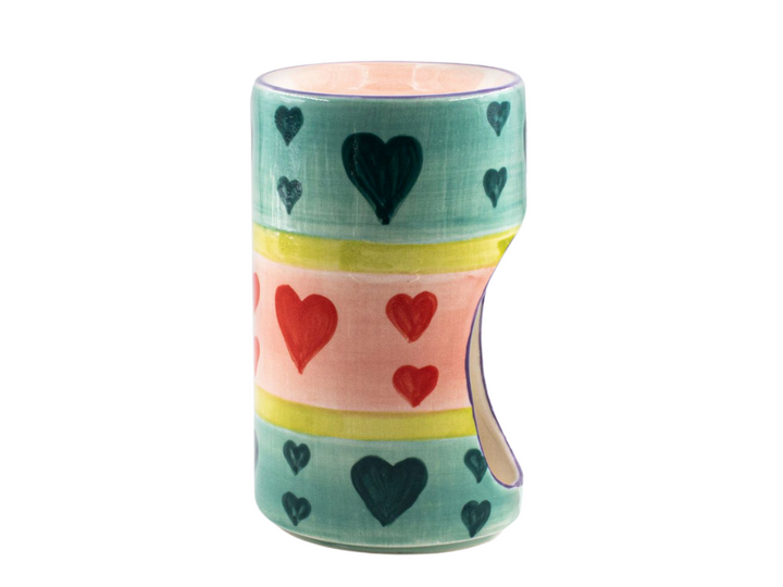 Pastel heats Ceramic Burner. Tea light in bottom that glows through the opening while scent burns on top. Colorful pastel hearts in green, blue and pink design pattern painted on side. Fair Trade.