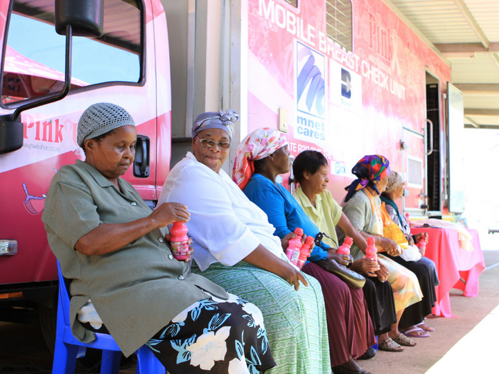 Local women waiting by the Pink Drive bus for their appointments.  Pink Drive sevices those who are not able to travel to a clinic for cancer screening.