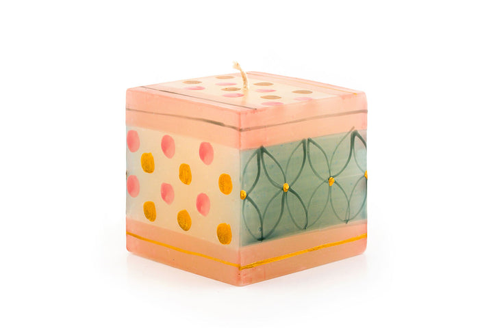 This 3" X 3" X 3" Pastel Gold cube candle glows from the inside while it burns. Handmade and hand painted. Fair Trade.